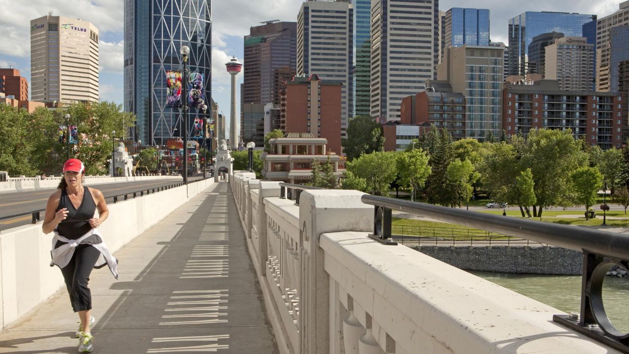 Someone jogging across a bridge in Calgary.