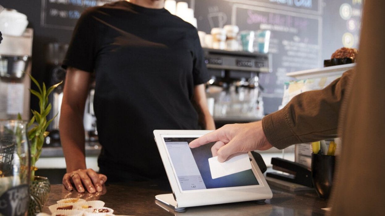 Someone paying at a coffee shop.