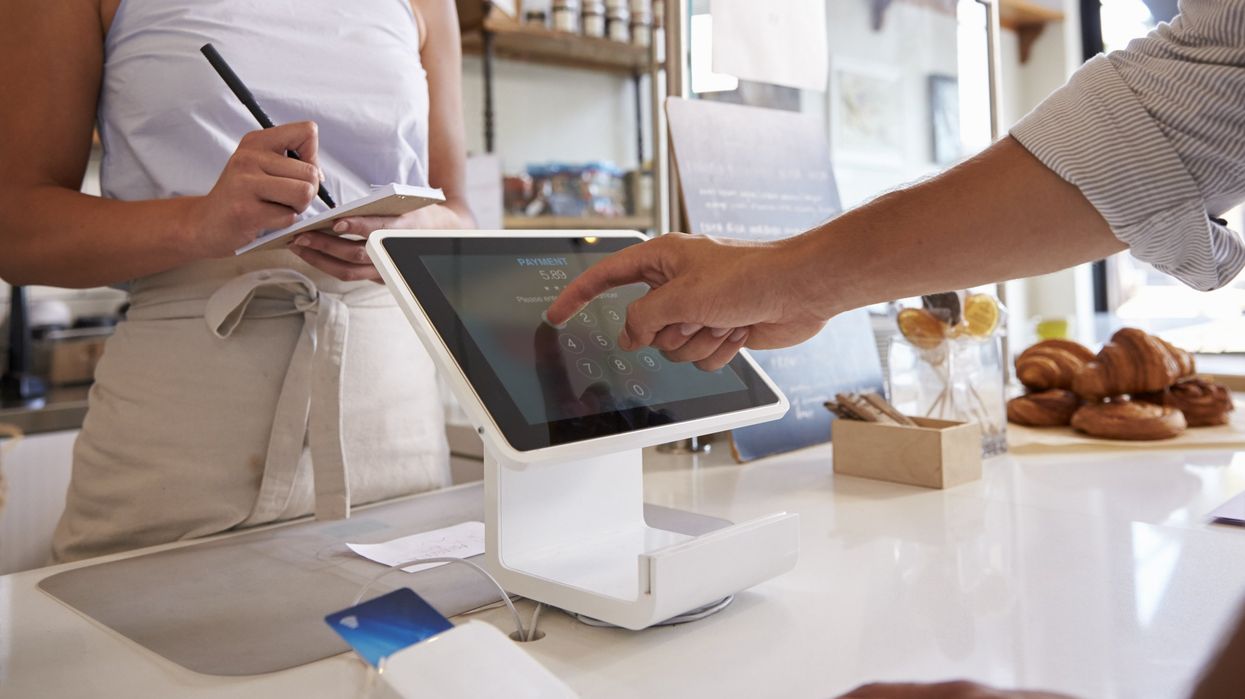 Someone paying at a payment terminal.