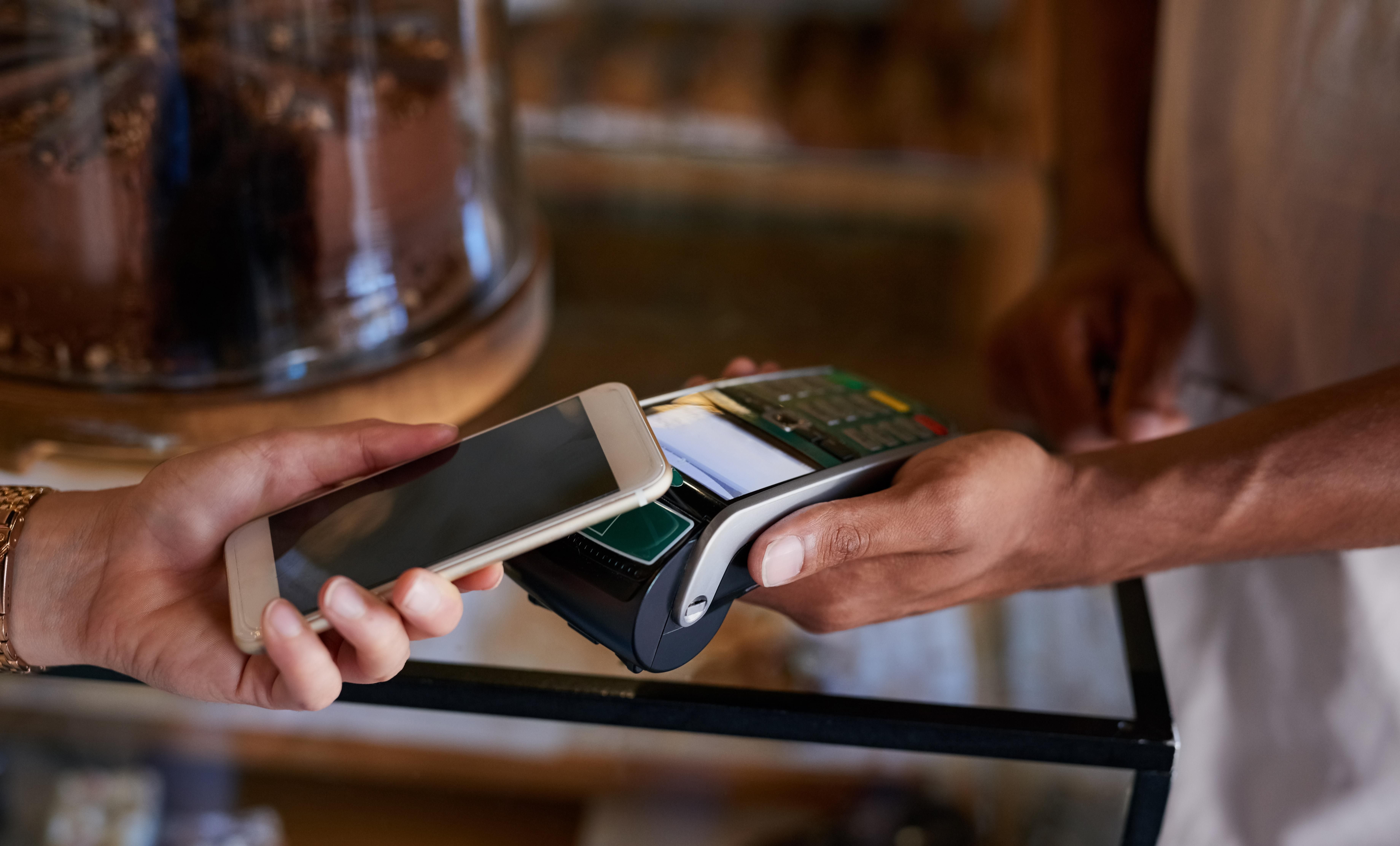 Someone paying using a debit machine.