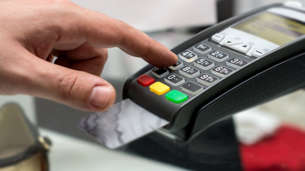 Someone pays at a card terminal.