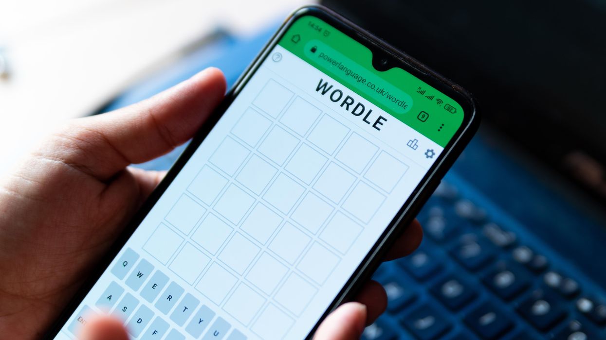 Someone playing wordle on their phone.