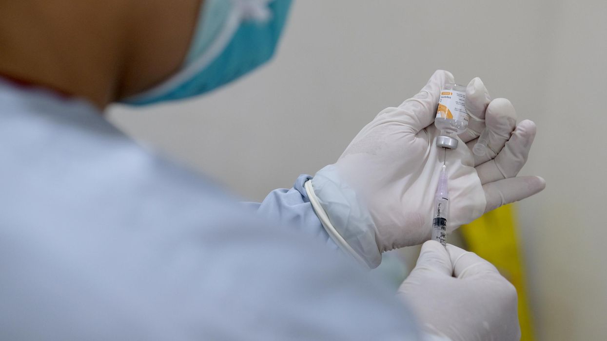 Someone preparing a COVID-19 vaccination.