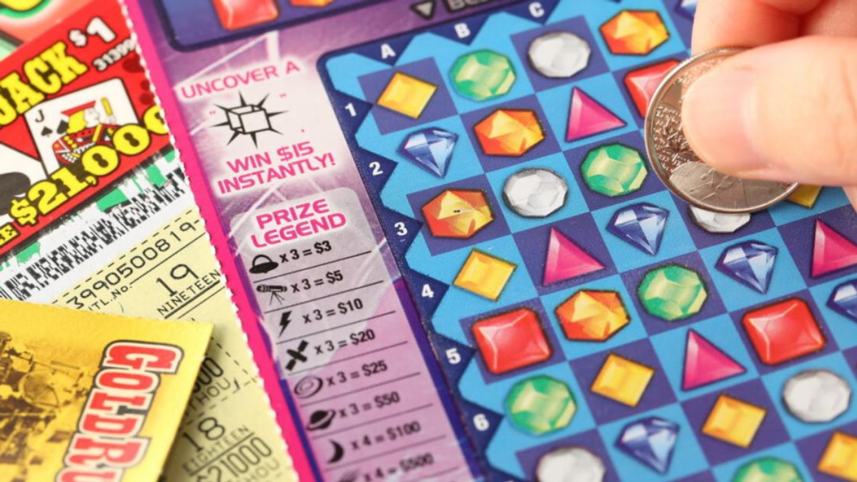 Someone scratching a lottery ticket.
