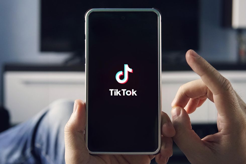 Someone using TikTok on their phone.