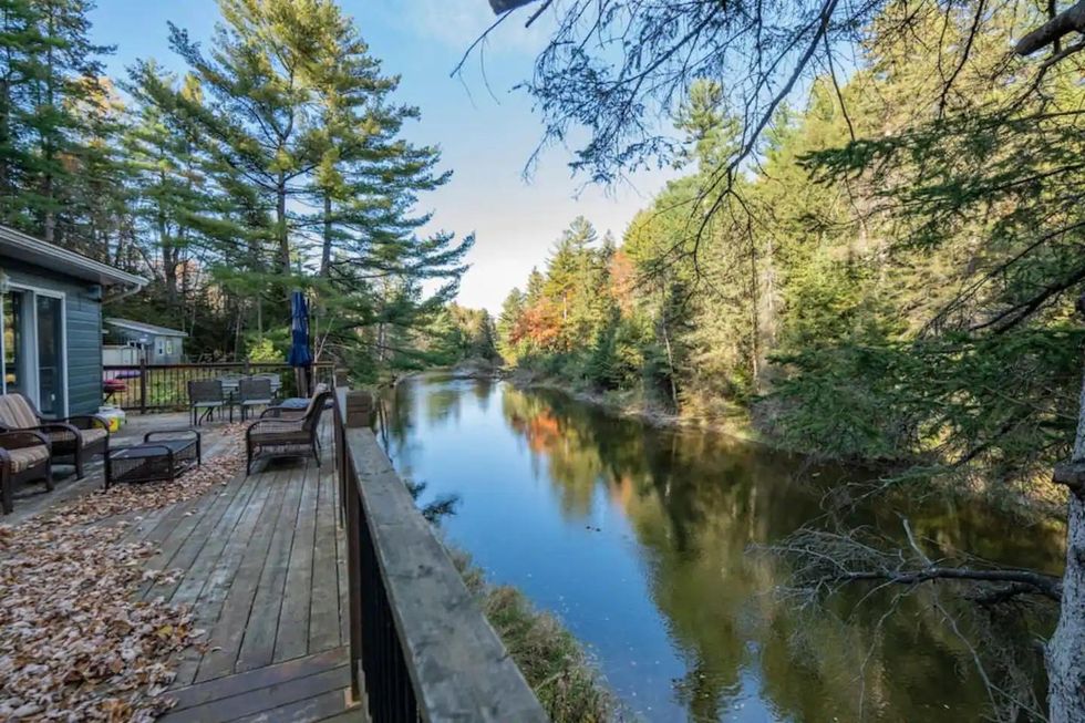 Spacious cottage deck overlooking a hidden river.