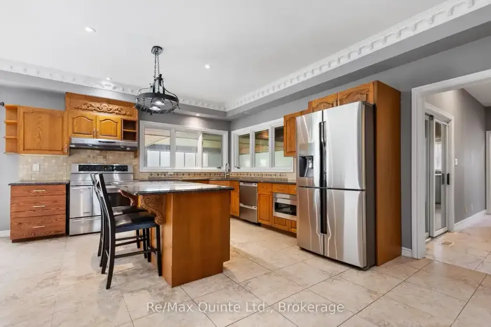 Spacious kitchen with modern appliances and wood cabinetry.