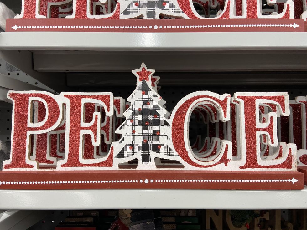 Sparkly wooden 'Peace' sign for Christmas decor.