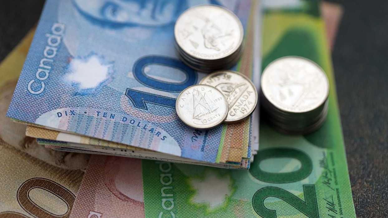 stack of canadian banknotes and coins