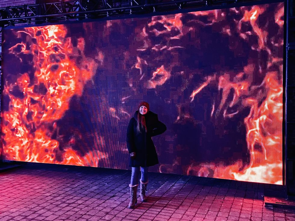 Standing in front of a fire blaze light installation along Bank Street in Ottawa.
