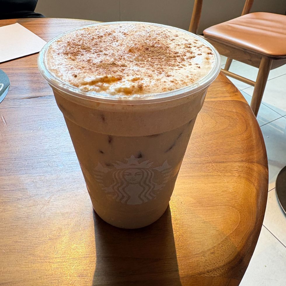 starbucks iced pumpkin cream chai tea latte on a wooden table