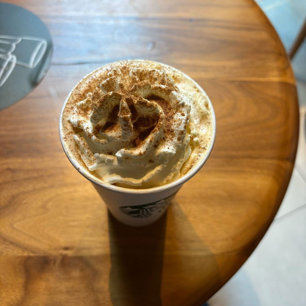 starbucks pumpkin spice latte on a wooden table