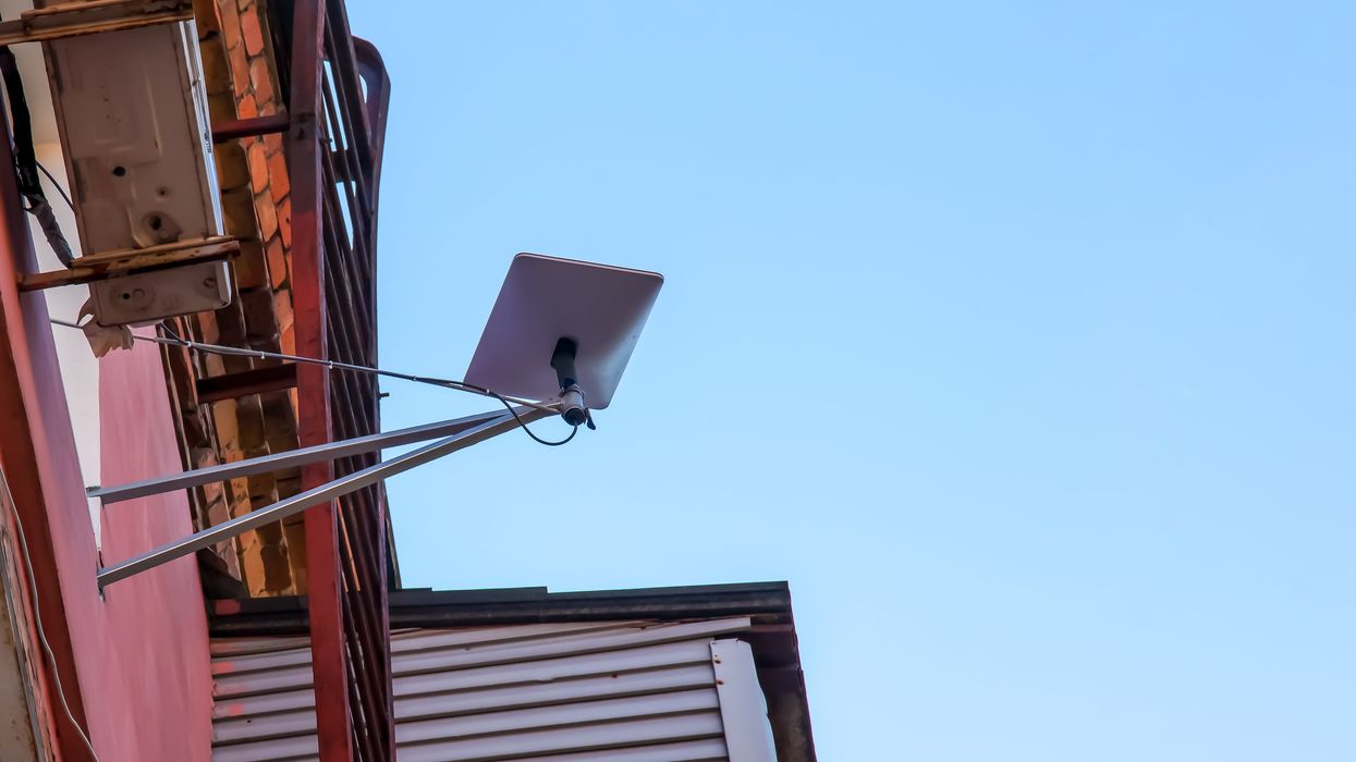 Starlink internet satellite dish on an apartment building.