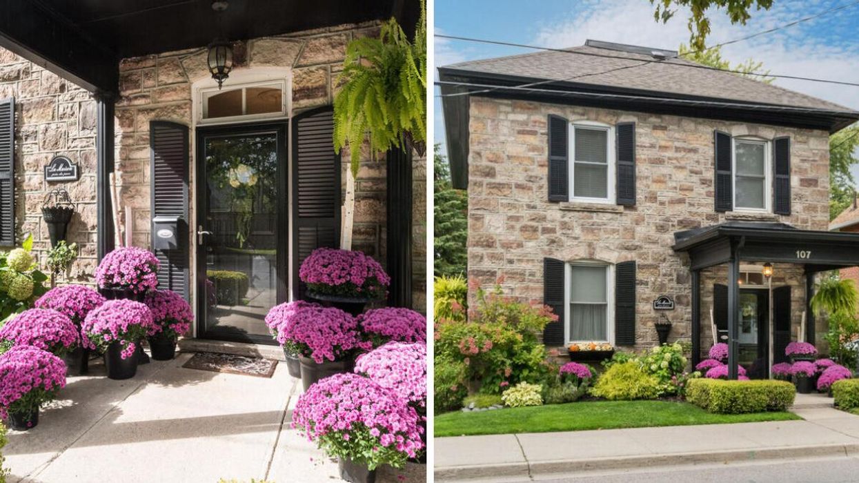 Stone home with purple flowers.