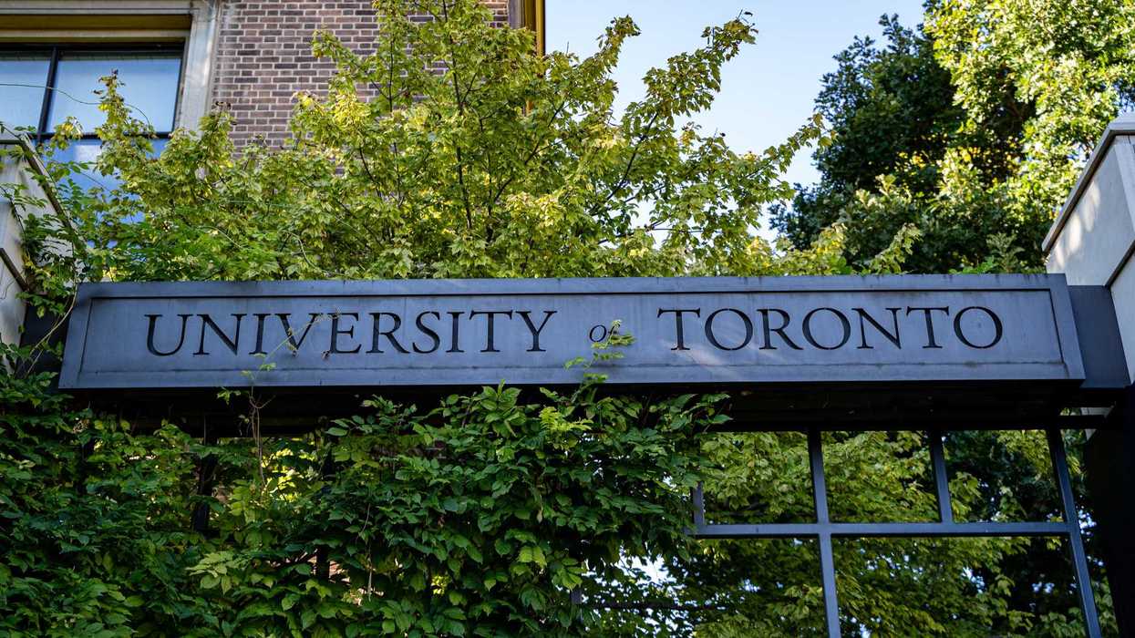 stone university of toronto sign in front of trees and building