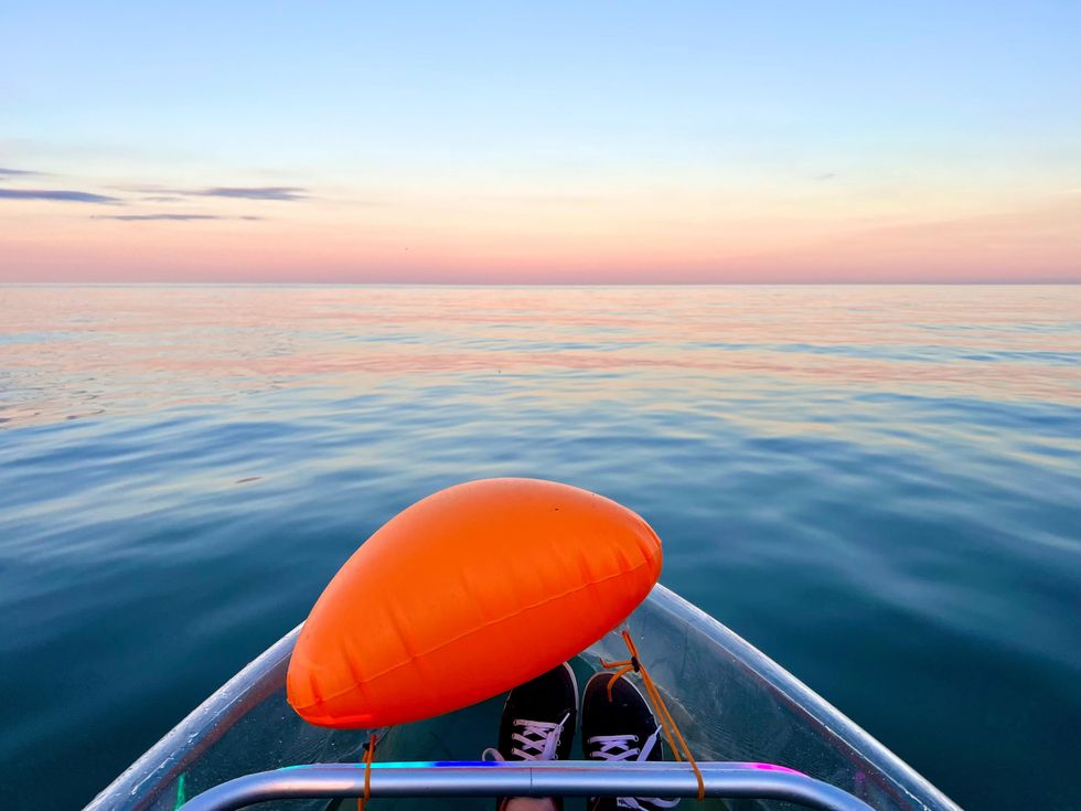 Sunset over Lake Ontario from a transparent kayak.