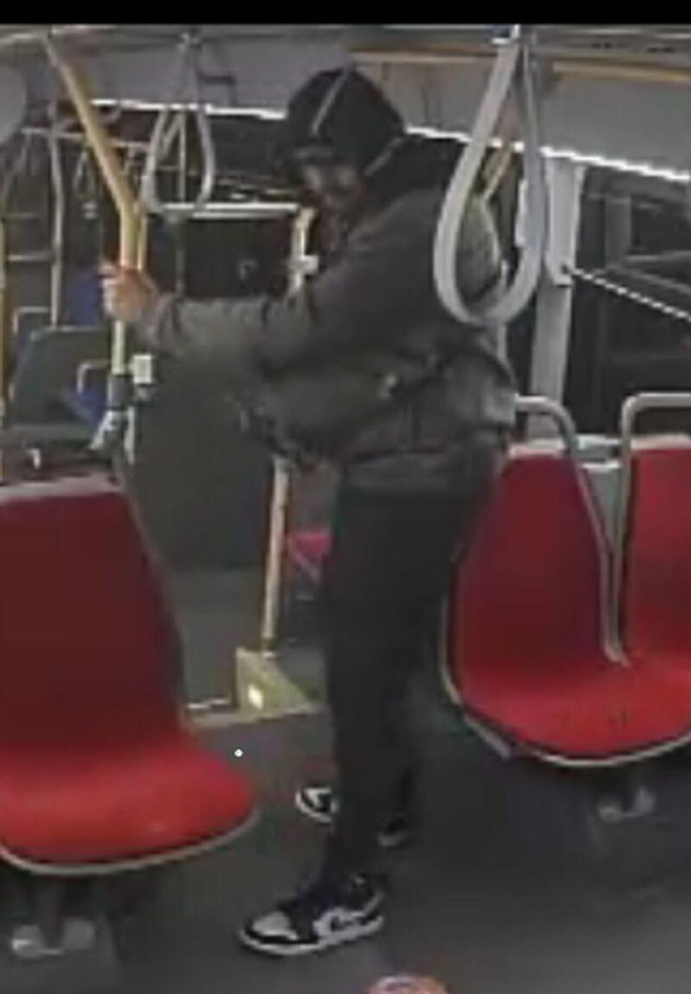Suspect holding on to yellow rail on TTC.