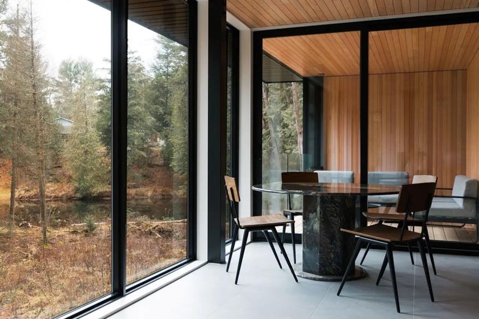 Table and chairs with forest views.