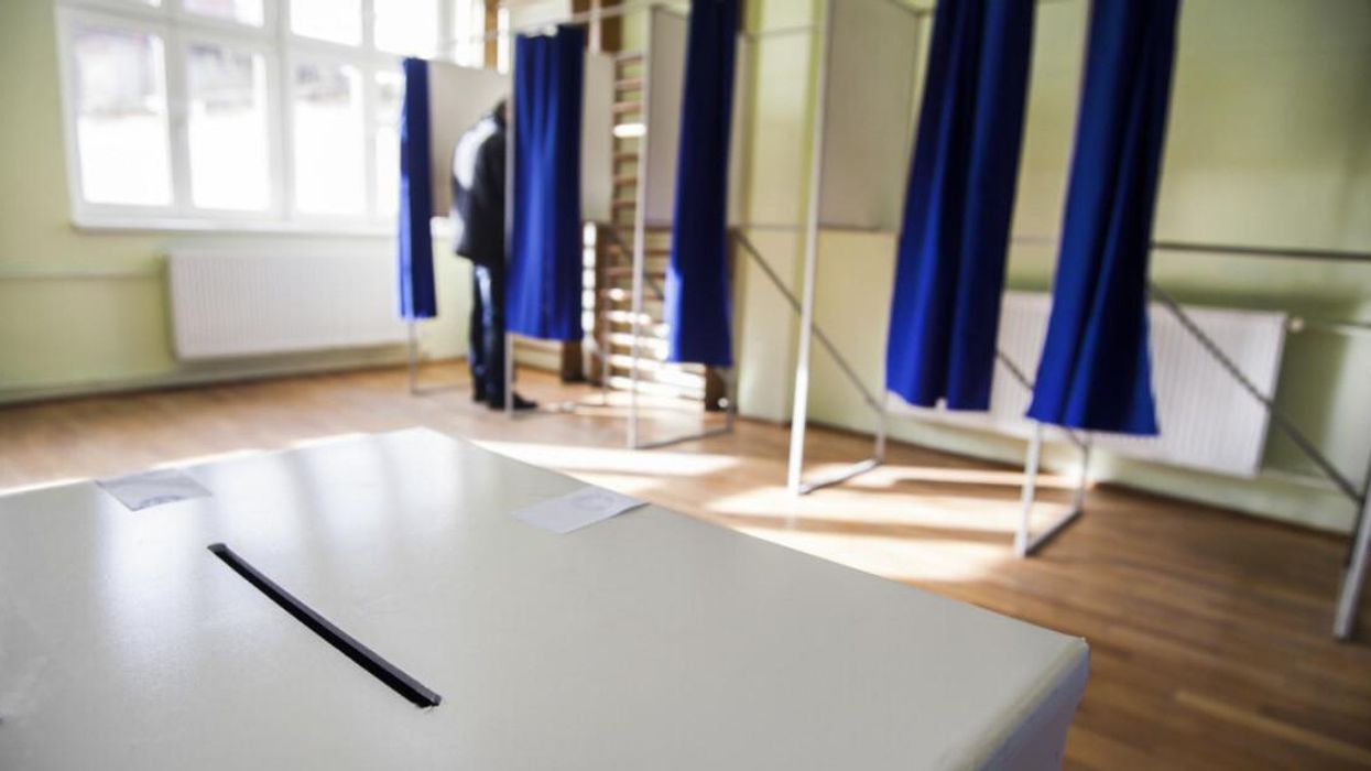 Table and voting cabins at a polling station.