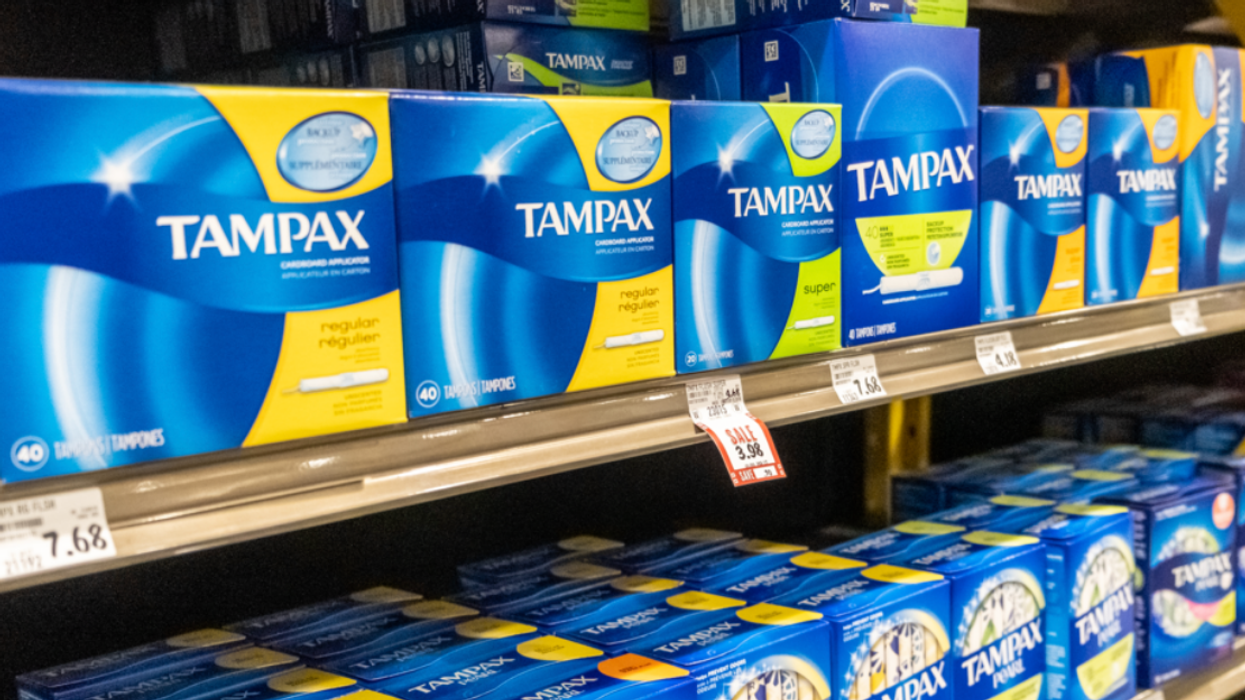 Tampax boxes on shelves.