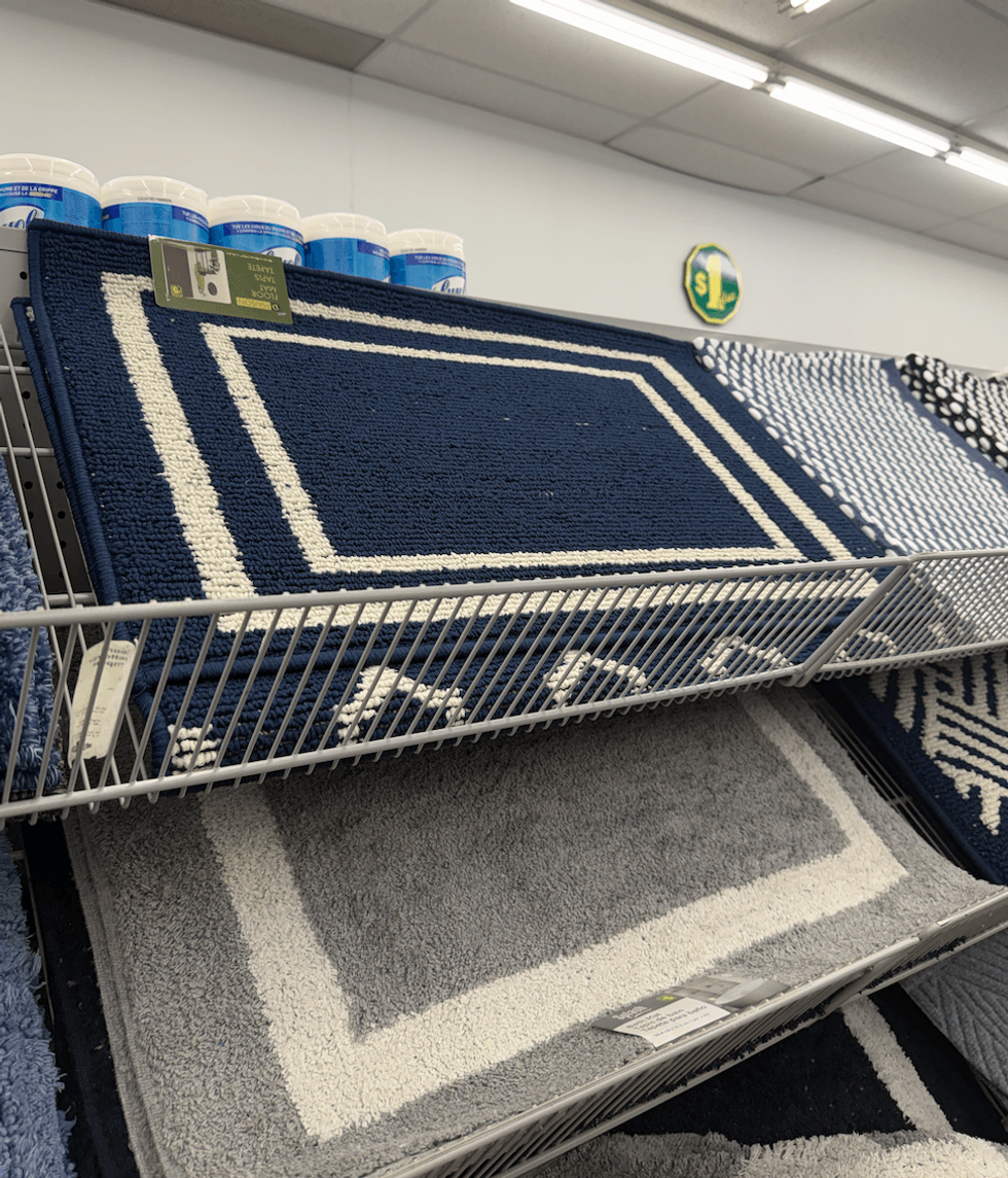 Tapis d\u00e9coratif bleu marine et un gris avec double bordure blanche vendu 5 $ chez Dollarama.