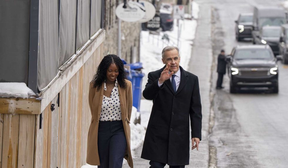 Tatiana Auguste and Mark Carney walk down a snowy Montreal street.
