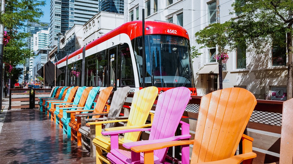 The 504 TTC streetcar passing St. James Park on King St. on a sunny day.