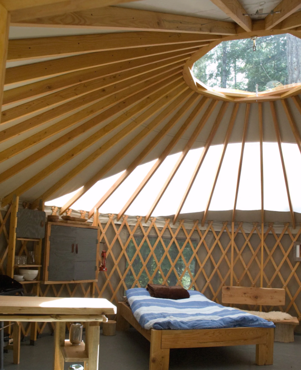 The bed, skylight and Inside of the yurt Airbnb.