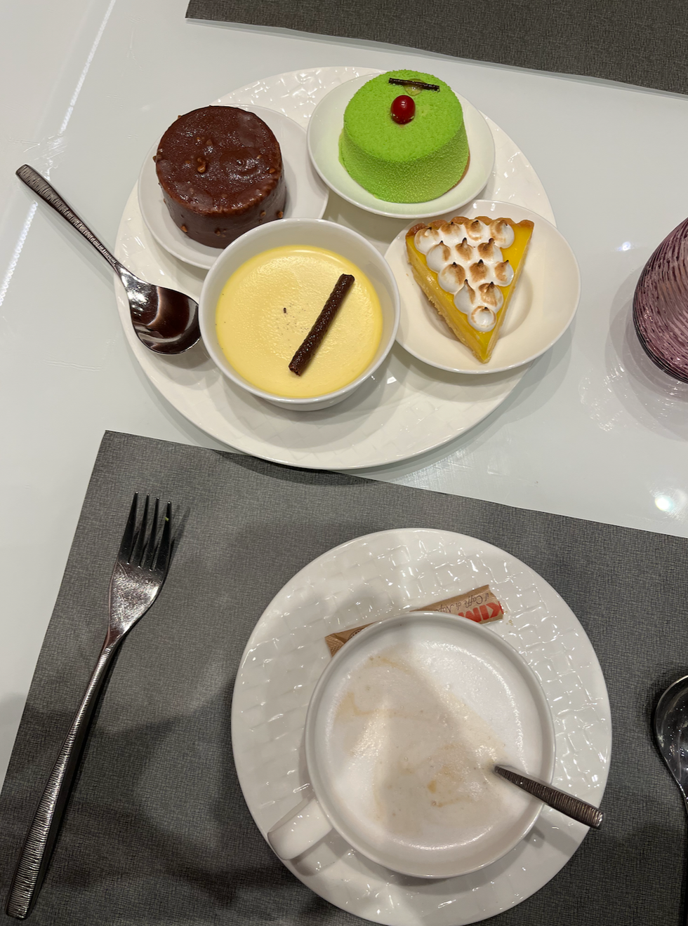 The desserts and cappuccino at the Qatar Airways Al Mourjan Business Lounge.