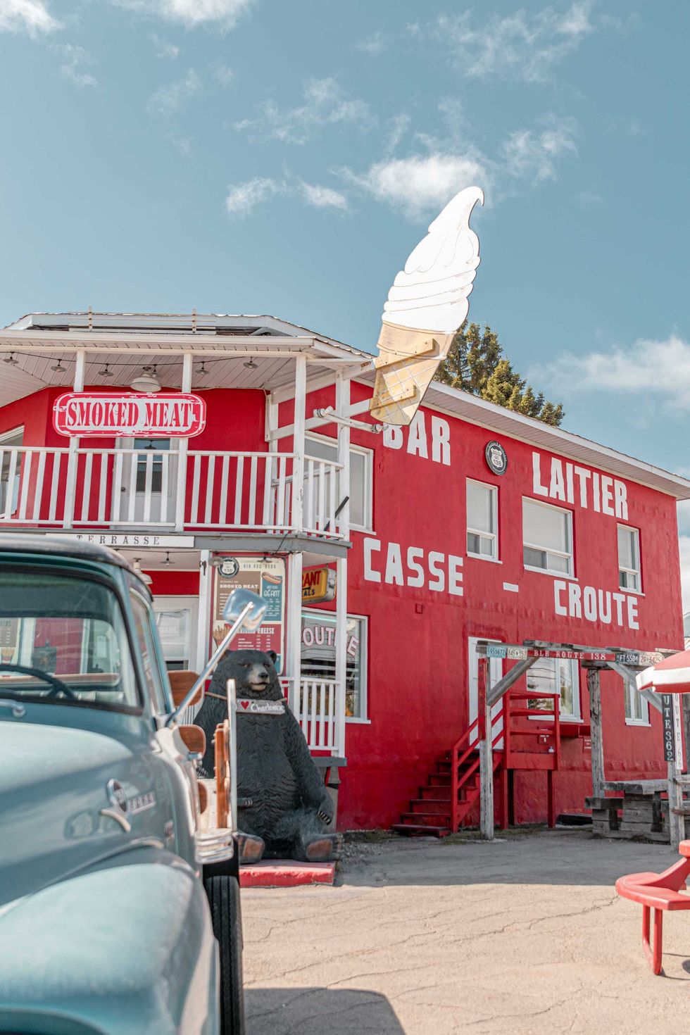 The exterior of a red roadside rest stop called Casse-Cro\u00fbte Route 138
