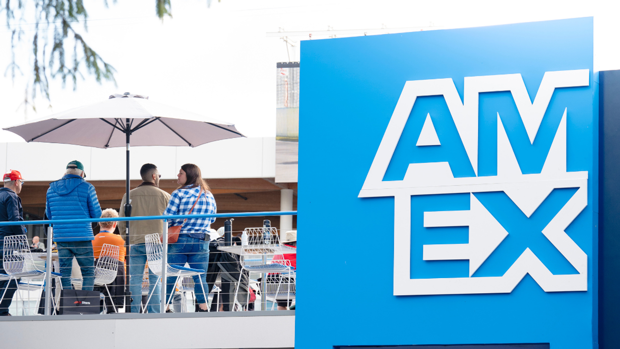 The exterior of the Trackside Lounge with a blue entryway reading "Amex."