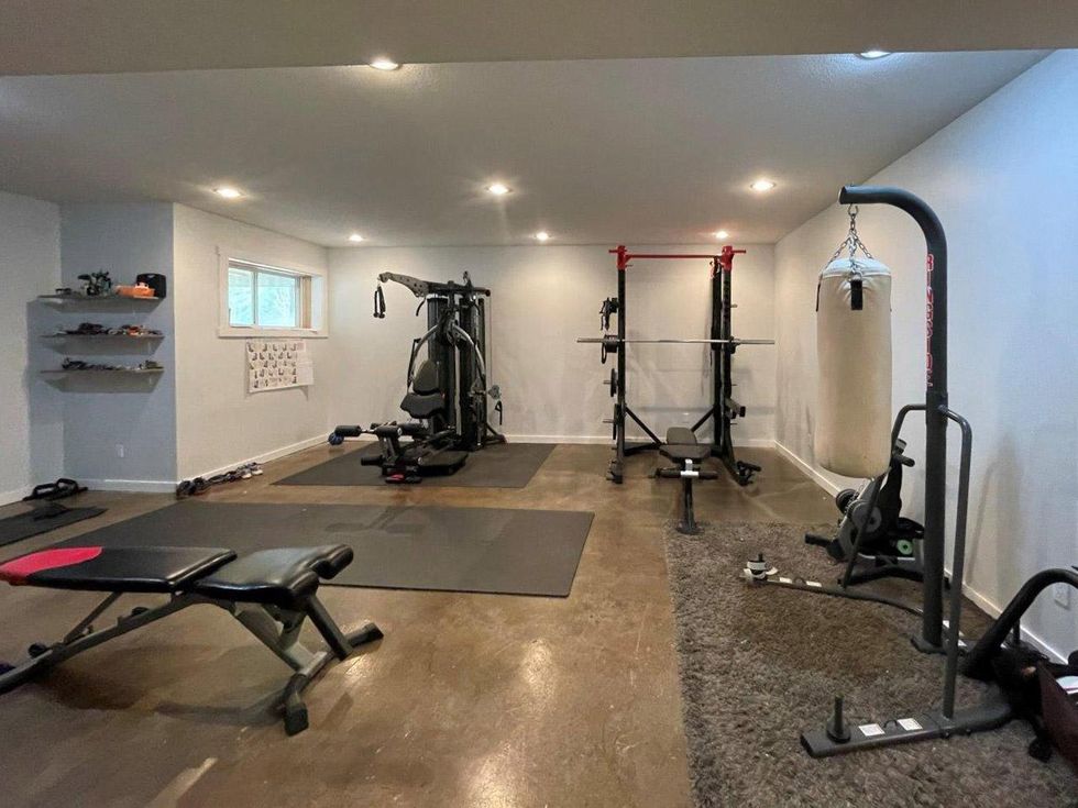 The gym room with the equipment in the house for sale.