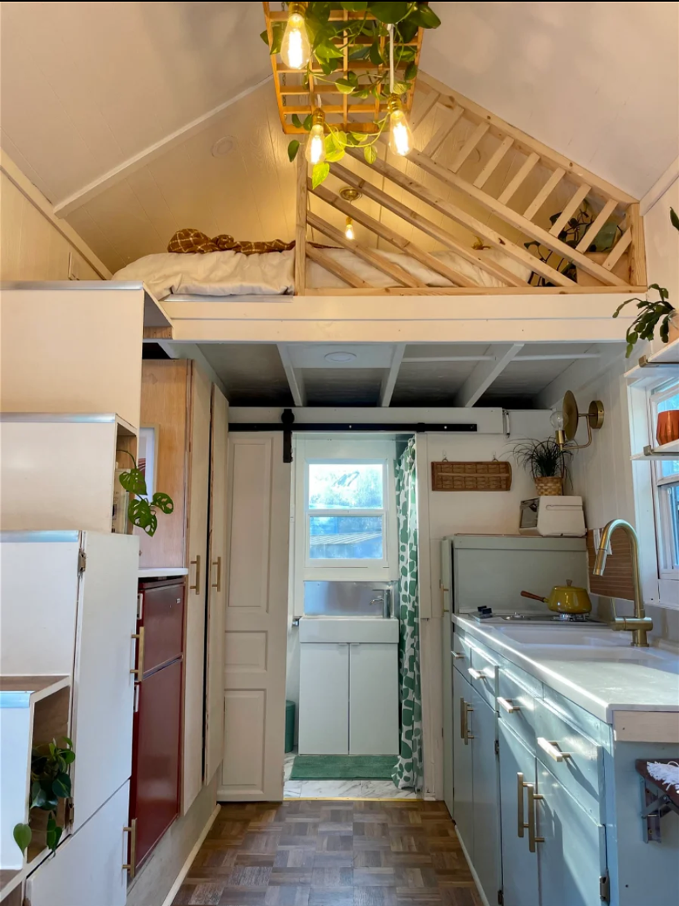 The kitchen and stairs leading up to the lofted bedroom.