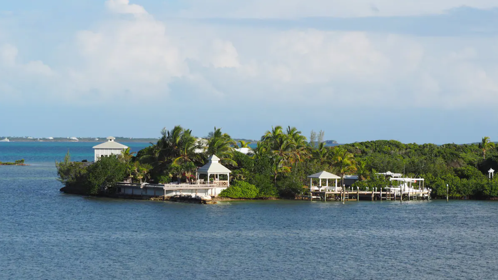 The lush trees and the dock in the middle of Elbow Cay.