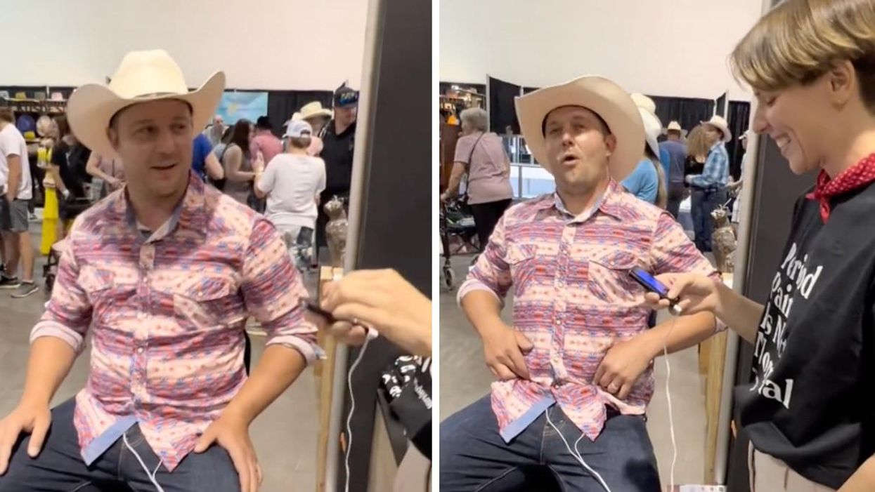 The man trying a period pain simulator at the Calgary Stampede.
