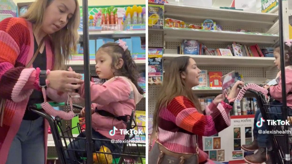 The mom with her daughter wearing a leash at a store.