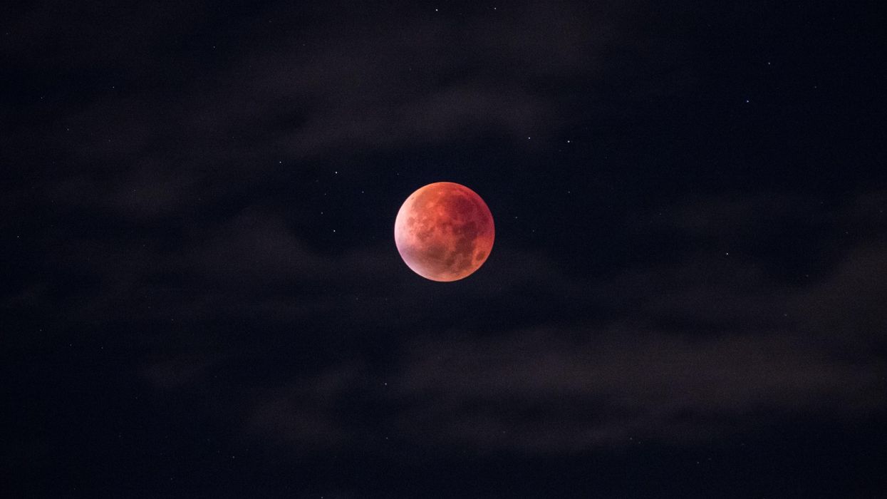 The moon turning red during a total lunar eclipse.