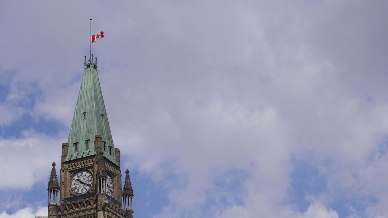 The Peace Tower flag being flown at half mast.