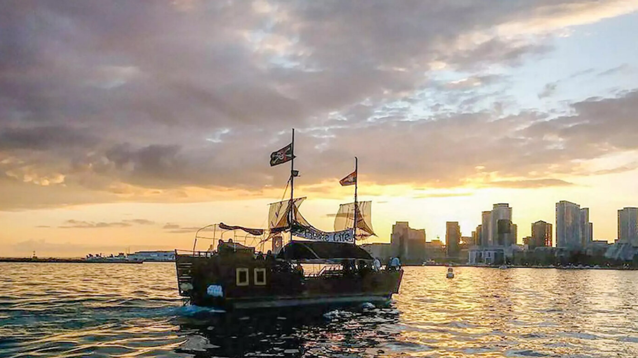 The Pirate Life ship on the water with buildings in the City of Toronto in the background.