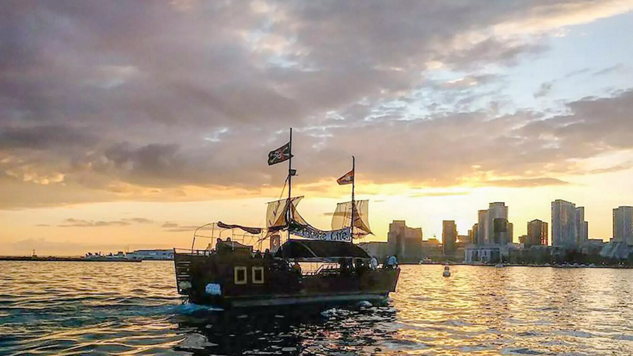 The Pirate Life ship on the water with buildings in the City of Toronto in the background.