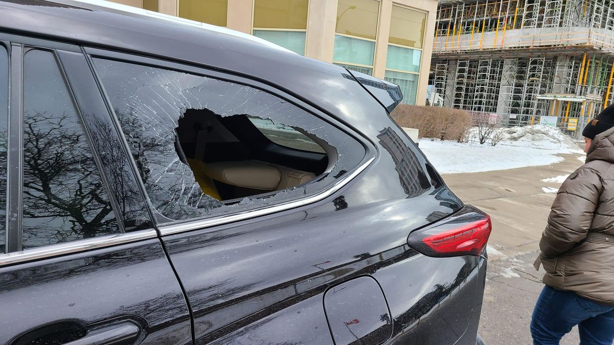 The smashed rear window of the car.