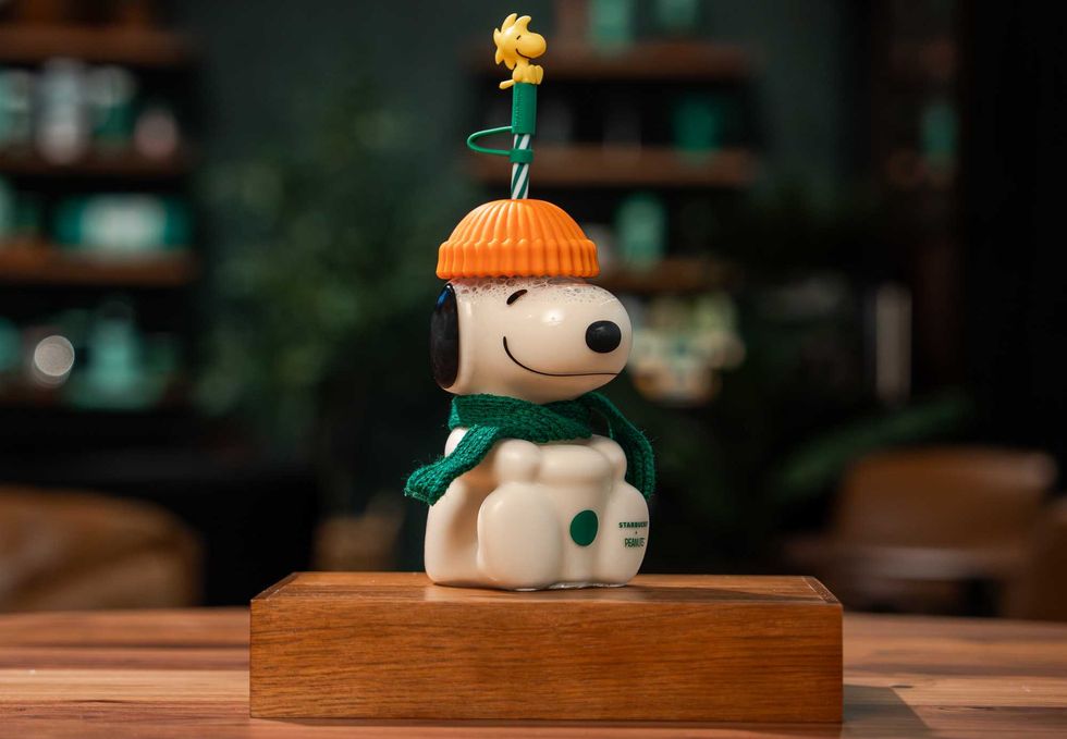 The Snoopy Glass Cold Cup features a charming Woodstock straw topper, pumpkin-coloured hat and a seasonal green scarf ($57.95).