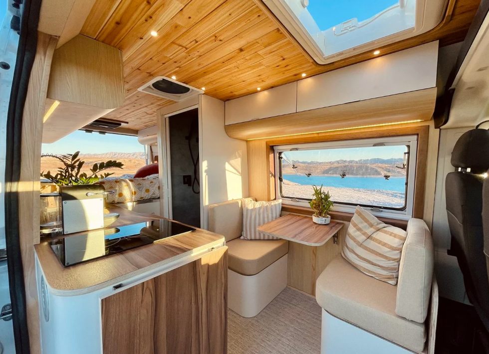 The windows and dining table inside a tiny home on wheels.