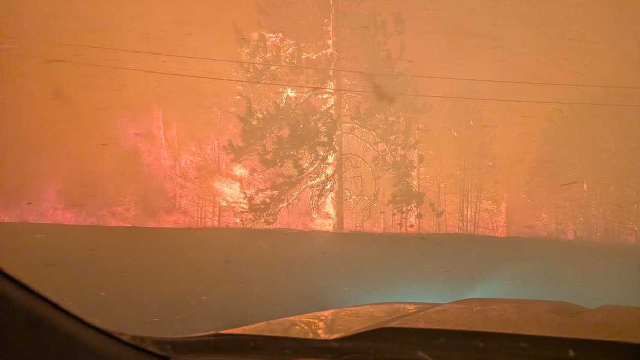 Thousands flee B.C. fire, RCMP say death reported