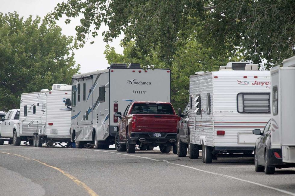 Thousands flee B.C. fire, RCMP say death reported