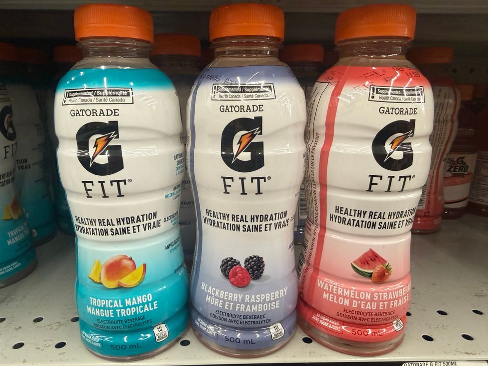 Three bottles of Gatorade, each in a different flavour and colours sitting on a store shelf.