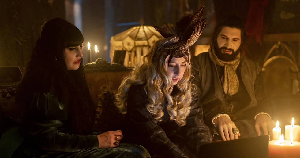 Three characters seen looking at a screen in the show What We Do in the Shadows.