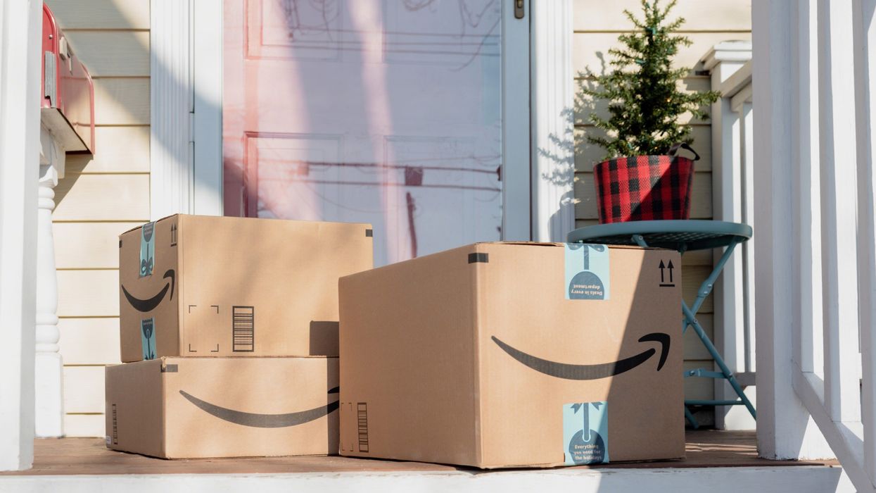 three large amazon boxes on a house's front porch