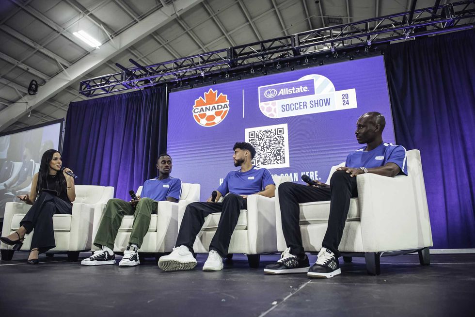 Three professional soccer players are interviewed on a panel.