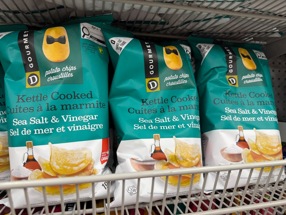 Three teal and white bags with a picture of chips on the front.